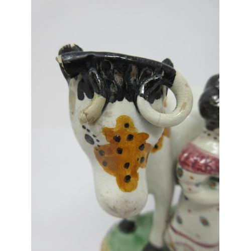 294 - A pair of early 19th Century pottery Cow and Calf with cowman and milk maid Figures on oblong bases,... 