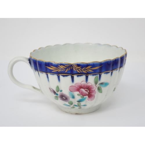 303 - A First Period Worcester Cup, Coffee Cup and Saucer, floral painted decoration, blue border with gil... 