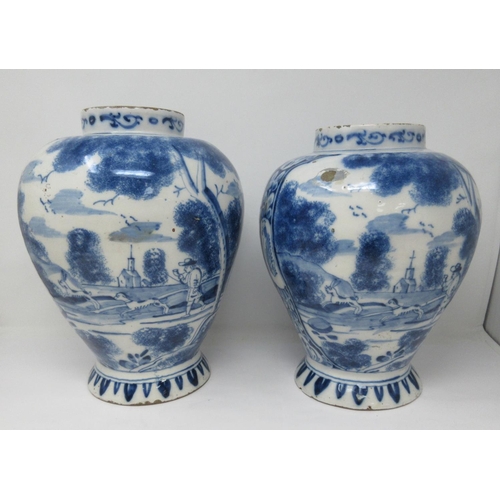 310 - A near pair of 18th Century Delft blue and white Jars painted with panels of hare coursing and a rom... 