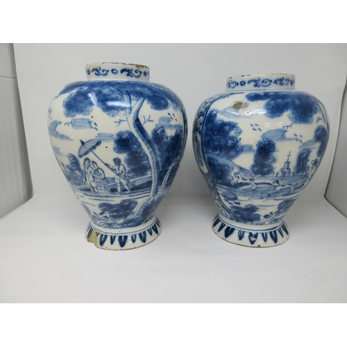 310 - A near pair of 18th Century Delft blue and white Jars painted with panels of hare coursing and a rom... 