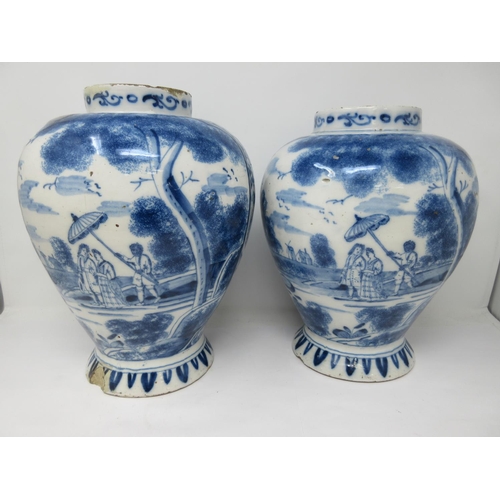 310 - A near pair of 18th Century Delft blue and white Jars painted with panels of hare coursing and a rom... 