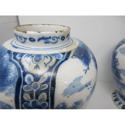 310 - A near pair of 18th Century Delft blue and white Jars painted with panels of hare coursing and a rom... 