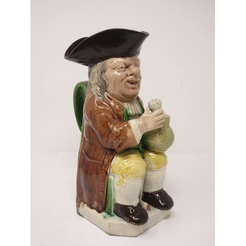 311 - A late 18th Century Ralph Wood Toby Jug wearing brown coat, yellow breeches, brown hat and green han... 