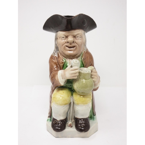 311 - A late 18th Century Ralph Wood Toby Jug wearing brown coat, yellow breeches, brown hat and green han... 