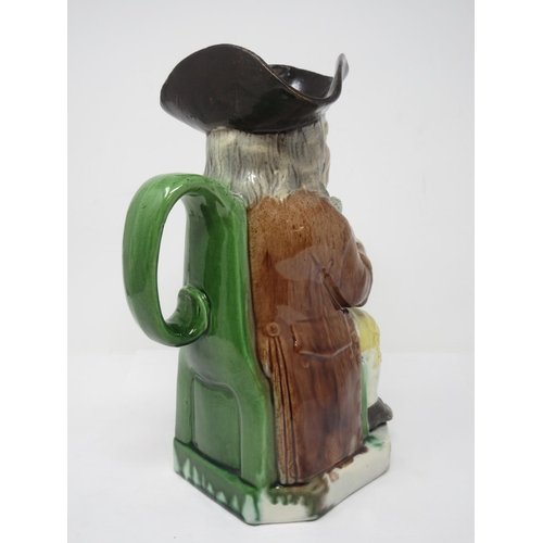 311 - A late 18th Century Ralph Wood Toby Jug wearing brown coat, yellow breeches, brown hat and green han... 