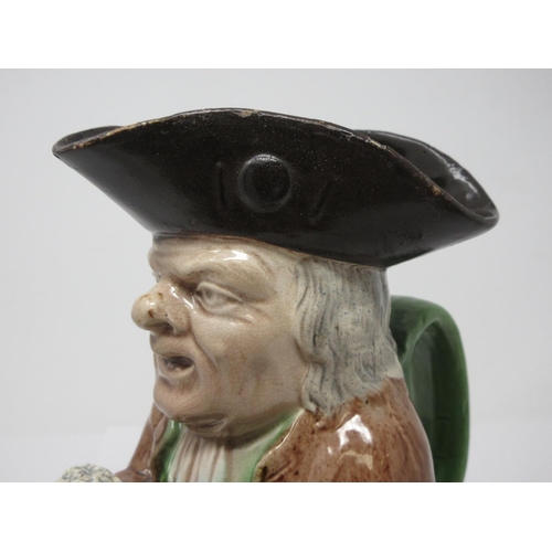 311 - A late 18th Century Ralph Wood Toby Jug wearing brown coat, yellow breeches, brown hat and green han... 