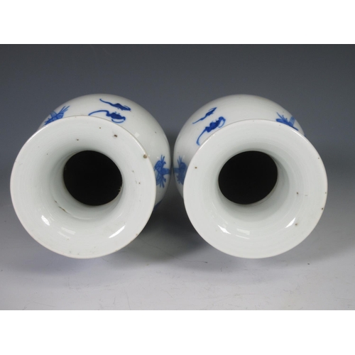 318 - A pair of 19th Century Chinese blue and white Vases of baluster form with flared rims decorated exot... 