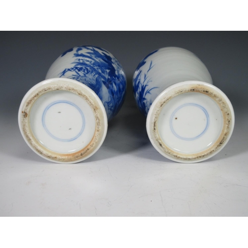 318 - A pair of 19th Century Chinese blue and white Vases of baluster form with flared rims decorated exot... 