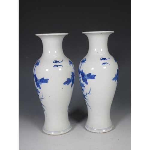 318 - A pair of 19th Century Chinese blue and white Vases of baluster form with flared rims decorated exot... 