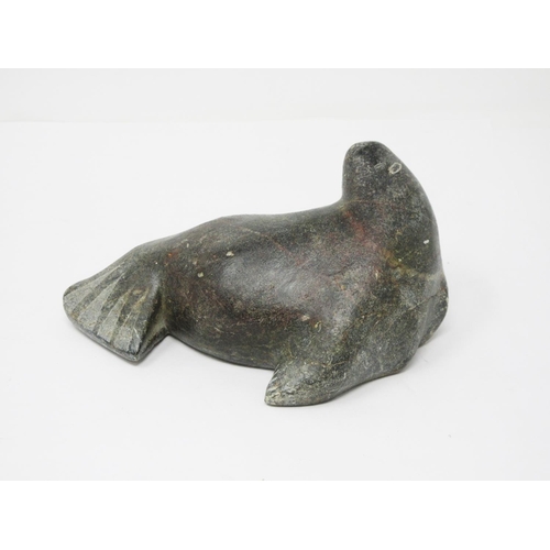 323 - An Inuit carved stone sculpture of a Walrus, scratch signed 'Jimmy' to underside 6 1/2in L