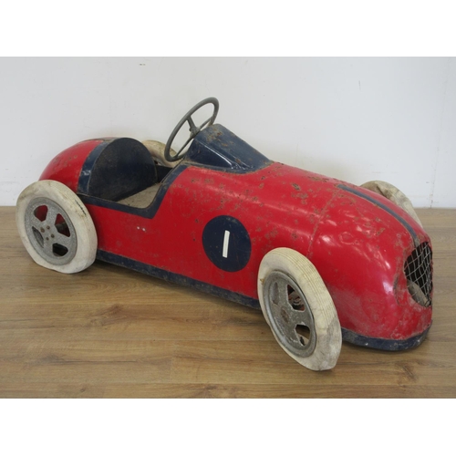 325 - A mid 20th Century Pedal Car with red and blue livery, with pneumatic tyres, requires some attention... 