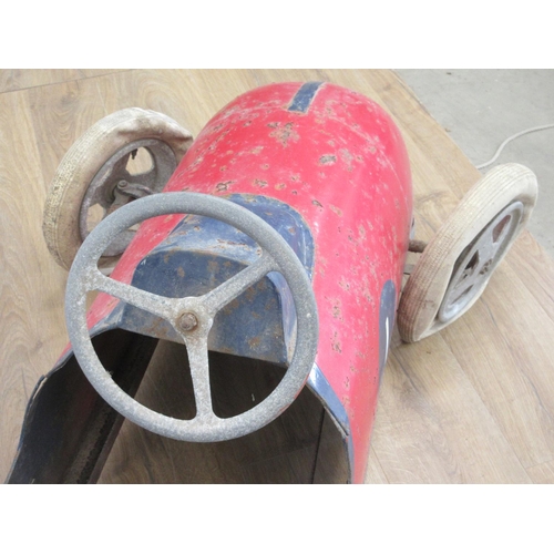 325 - A mid 20th Century Pedal Car with red and blue livery, with pneumatic tyres, requires some attention... 