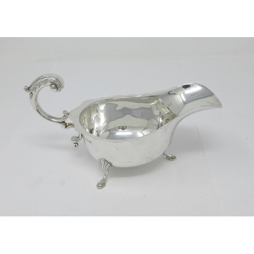 33 - A George V silver Sauce Boat with leafage scroll handle on hoof feet, Birmingham 1932, 134gms