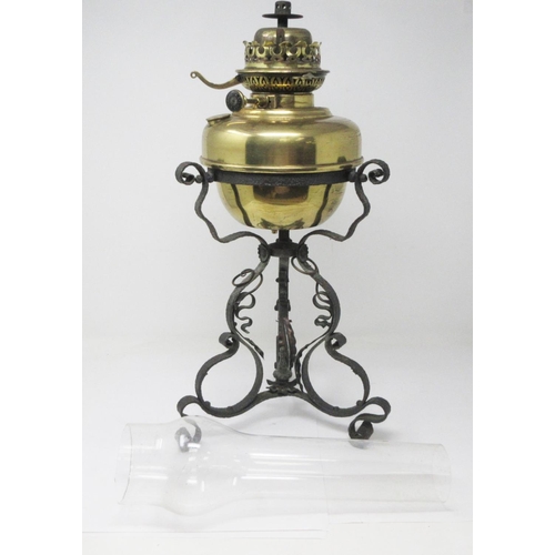 356 - A brass Paraffin Lamp on wrought iron base of scroll design