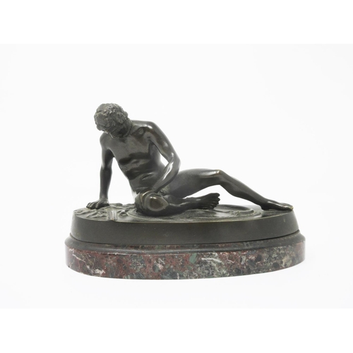 363 - A bronze seated Figure of a naked gladiator with a wound to his chest on an oval marble base, 6 1/2i... 