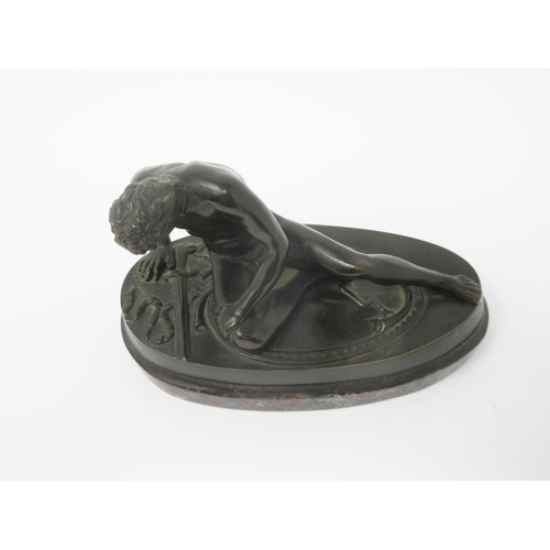 363 - A bronze seated Figure of a naked gladiator with a wound to his chest on an oval marble base, 6 1/2i... 