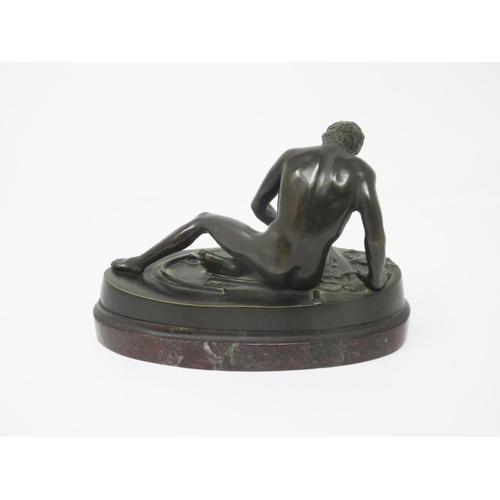 363 - A bronze seated Figure of a naked gladiator with a wound to his chest on an oval marble base, 6 1/2i... 