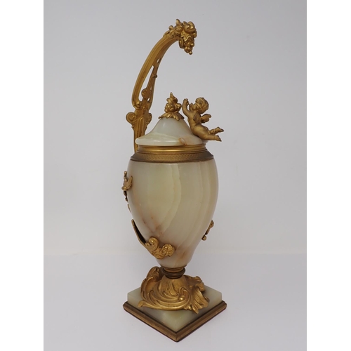 364 - A marble and gilded bronze Vase and Cover, the cover mounted with a cherub reaching for a grapevine,... 