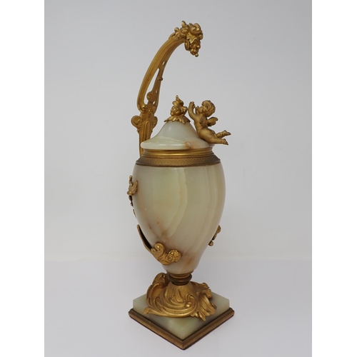 364 - A marble and gilded bronze Vase and Cover, the cover mounted with a cherub reaching for a grapevine,... 