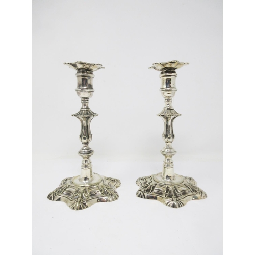 372 - A pair of mid 18th Century silver-form Paktong Candlesticks with knopped stems and petal bases, 9in ... 