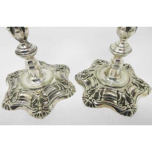 372 - A pair of mid 18th Century silver-form Paktong Candlesticks with knopped stems and petal bases, 9in ... 