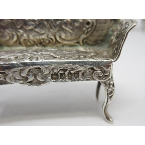 38 - A Victorian Continental silver miniature Table, Settee and six Chairs, decorated figures, scroll, et... 