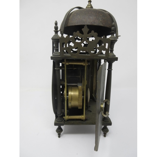 387 - An 18th Century style Lantern Clock with later movement, brass chapter ring and striking on a bell, ... 