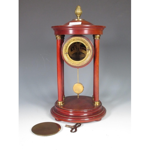 391 - An Empire style portico Mantel Clock with gilt acorn finial, the circular dial decorated floral swag... 