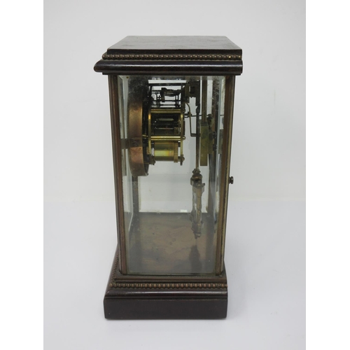 399 - A 19th Century French mahogany and glazed Mantle Clock with brass beading and enamel dial with Roman... 