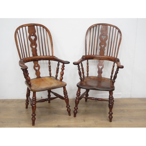 439 - A near pair of early 19th Century elm and yew wood broad arm Windsor Chairs with pierced heart splat... 