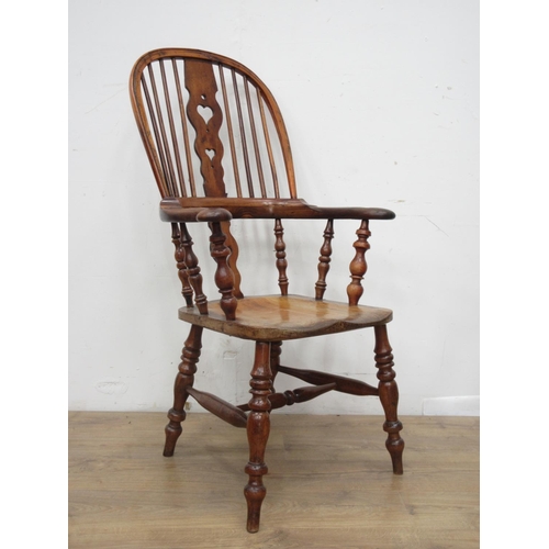 439 - A near pair of early 19th Century elm and yew wood broad arm Windsor Chairs with pierced heart splat... 