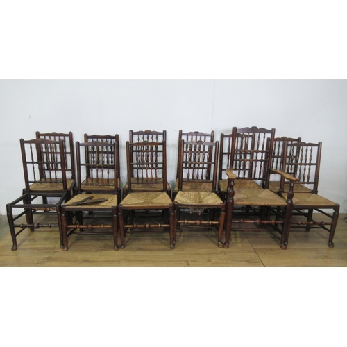 440 - A set of twelve 19th Century spindle back Dining Chairs with rush seats on turned front legs having ... 