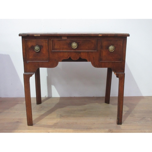 441 - A Georgian walnut Lowboy fitted three drawers with a quarter veneered and crossbanded top, fitted th... 