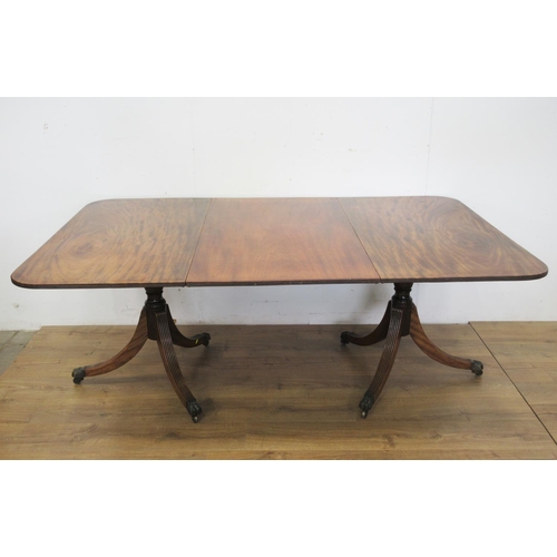 447 - A 19th Century mahogany Twin Pillar Dining Table, the reeded edge rectangular top and leaf raised on... 