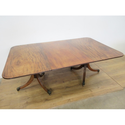 447 - A 19th Century mahogany Twin Pillar Dining Table, the reeded edge rectangular top and leaf raised on... 