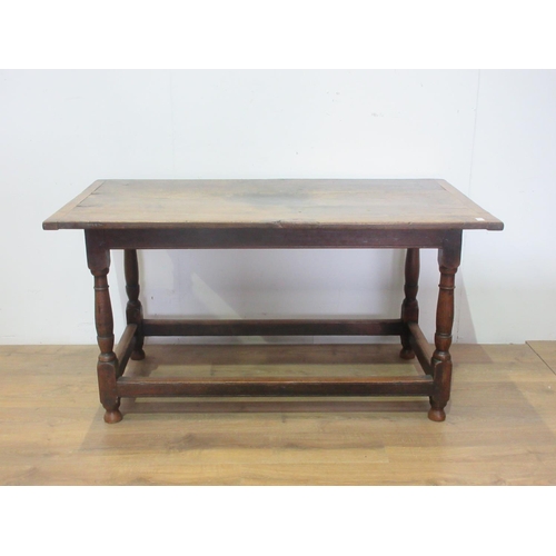 451 - An 18th Century oak Dining Table, the three plank cleated top above a moulded freize on turned legs ... 