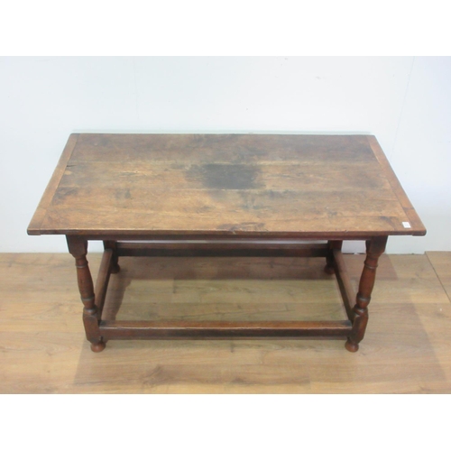 451 - An 18th Century oak Dining Table, the three plank cleated top above a moulded freize on turned legs ... 