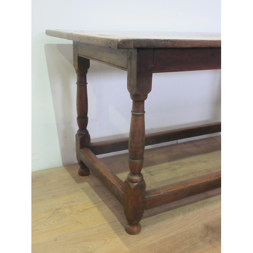 451 - An 18th Century oak Dining Table, the three plank cleated top above a moulded freize on turned legs ... 