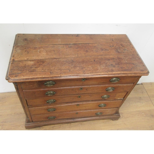 475 - A 19th Century elm Chest of four long drawers with quarter round pilasters and raised on bracket sup... 