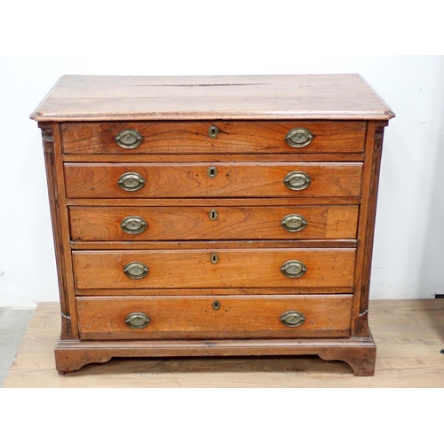 475 - A 19th Century elm Chest of four long drawers with quarter round pilasters and raised on bracket sup... 