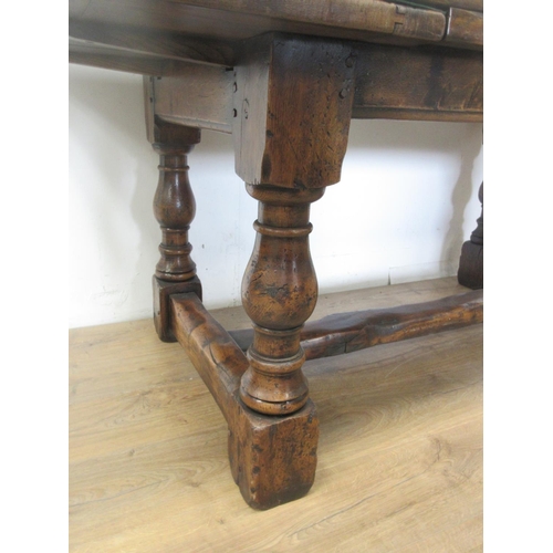 481 - An oak drawleaf Dining Table in the 18th Century style with cleated top on baluster supports and squ... 