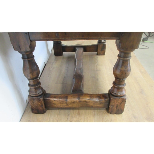 481 - An oak drawleaf Dining Table in the 18th Century style with cleated top on baluster supports and squ... 