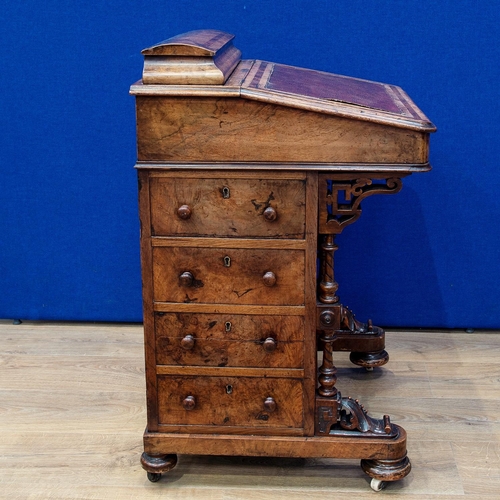 482 - A Victorian walnut Davenport Desk with hinged top enclosing letter rack, the sloping front enclosing... 