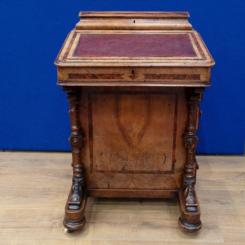 482 - A Victorian walnut Davenport Desk with hinged top enclosing letter rack, the sloping front enclosing... 