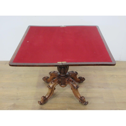 492 - A Victorian rosewood fold over Card Table with red baize lined surface and mounted upon gadrooned pi... 