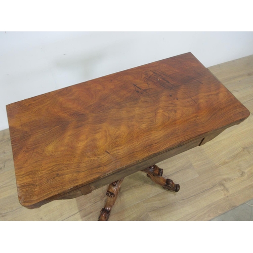 492 - A Victorian rosewood fold over Card Table with red baize lined surface and mounted upon gadrooned pi... 