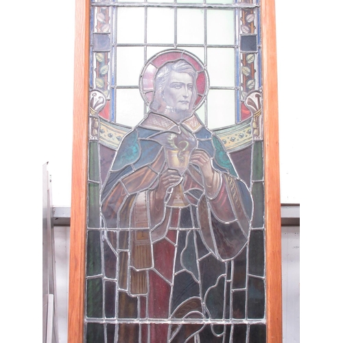 499 - A late 19th Century coloured leaded glass church Window depicting St John in modern oak frame 11ft 6... 