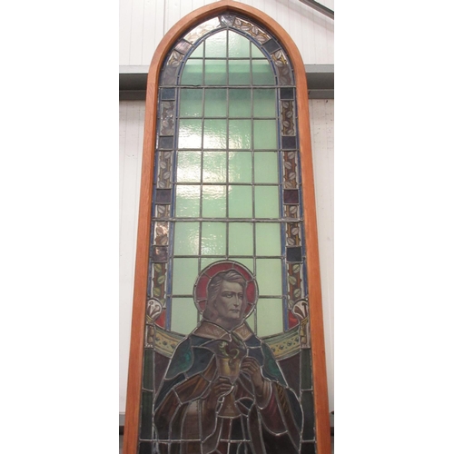 499 - A late 19th Century coloured leaded glass church Window depicting St John in modern oak frame 11ft 6... 