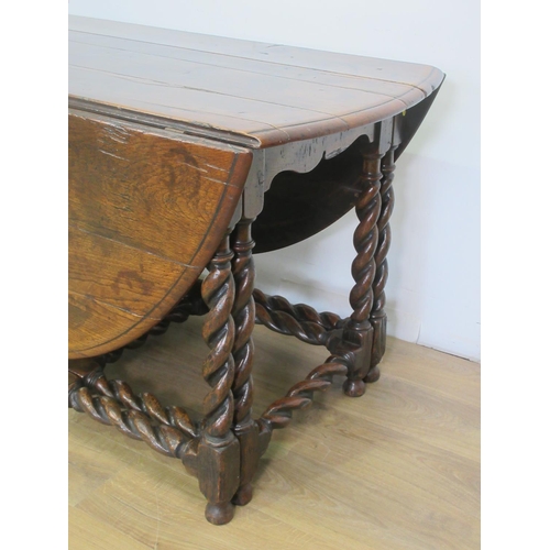 503 - An oak Gateleg Table in the Georgian style with moulded oval top, the leaves supported on double gat... 