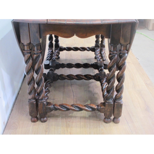 503 - An oak Gateleg Table in the Georgian style with moulded oval top, the leaves supported on double gat... 